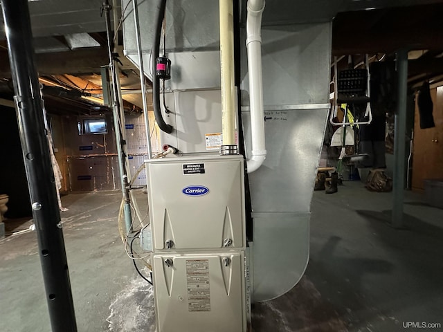 utility room featuring heating unit