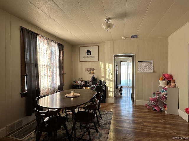 dining space with dark hardwood / wood-style floors