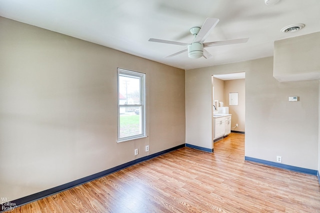 unfurnished room with ceiling fan and light hardwood / wood-style floors