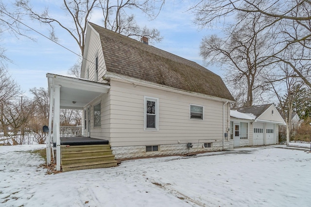 exterior space with a porch and a garage