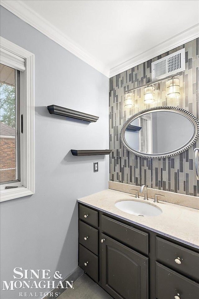 bathroom featuring crown molding and vanity