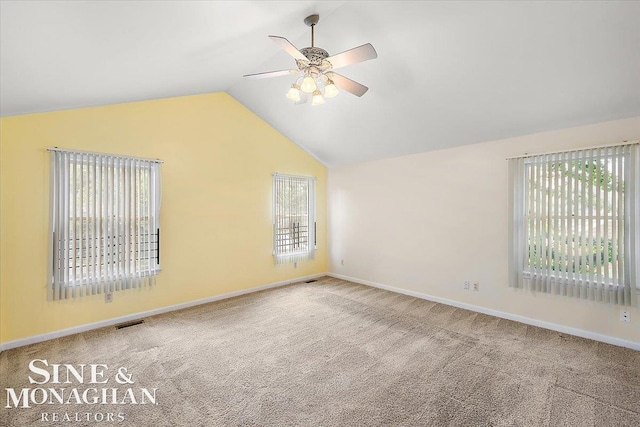 carpeted spare room with lofted ceiling and ceiling fan