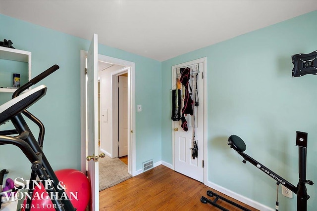 workout room featuring wood-type flooring