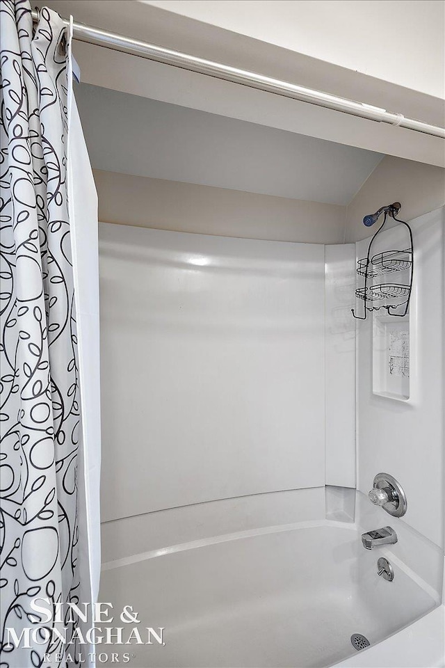 bathroom with shower / bath combination with curtain