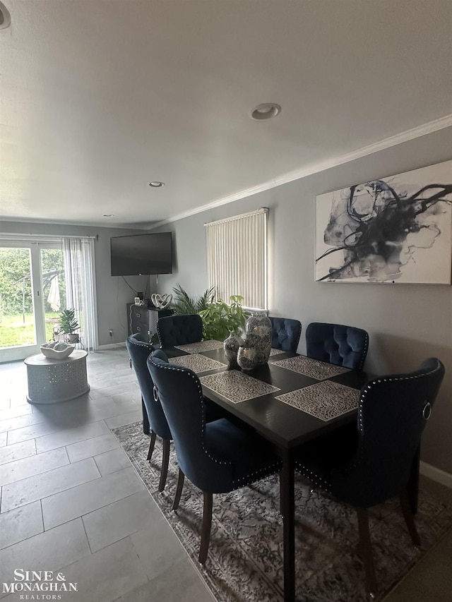 dining space with crown molding