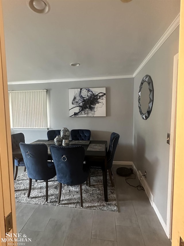 dining space with tile patterned floors and ornamental molding