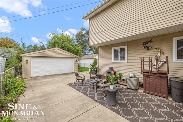 view of patio / terrace featuring a garage and an outdoor structure