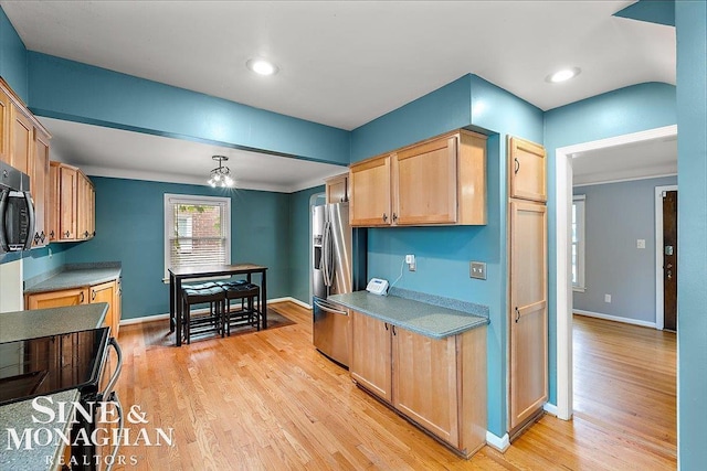 kitchen featuring stainless steel refrigerator with ice dispenser, light brown cabinetry, and light hardwood / wood-style flooring