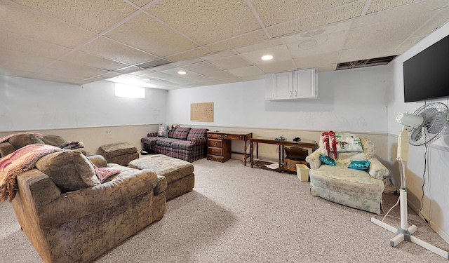 carpeted living room with a paneled ceiling