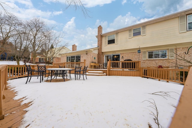 snow covered property featuring a deck