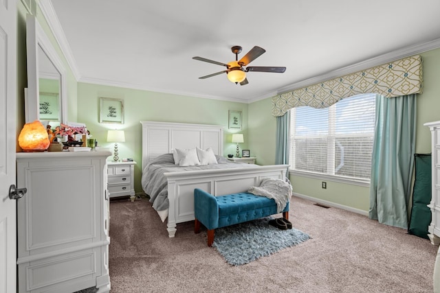 carpeted bedroom with crown molding and ceiling fan