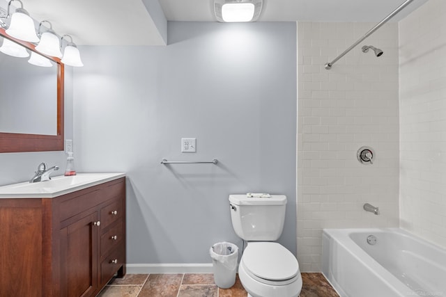 full bathroom featuring vanity, tiled shower / bath, and toilet