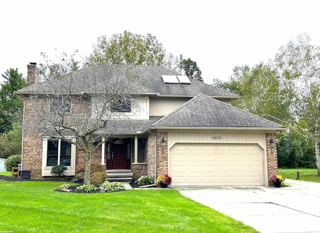 view of front of home featuring a garage and a front yard