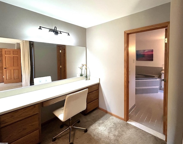 bathroom featuring vanity and tiled bath