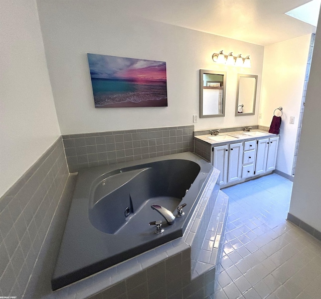 bathroom with vanity, a relaxing tiled tub, and tile patterned floors