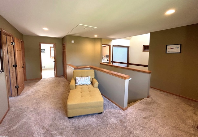 sitting room featuring light colored carpet