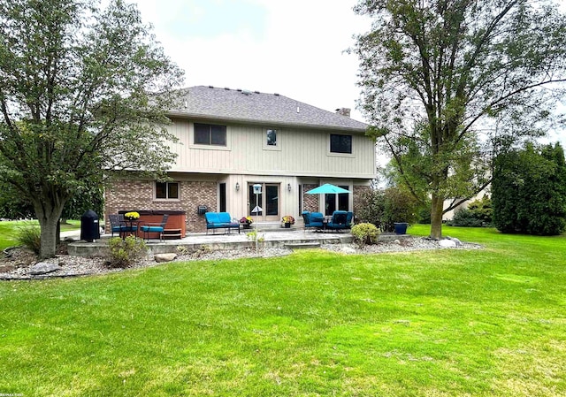 back of house featuring a lawn and a patio