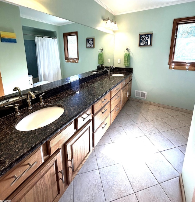 bathroom with crown molding, vanity, tile patterned floors, and toilet