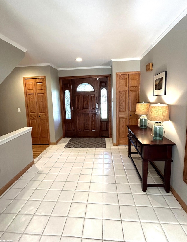 tiled foyer featuring crown molding