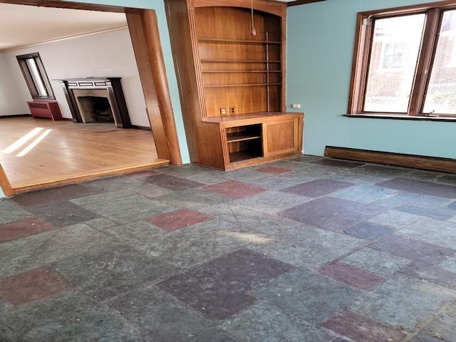 unfurnished living room featuring built in shelves