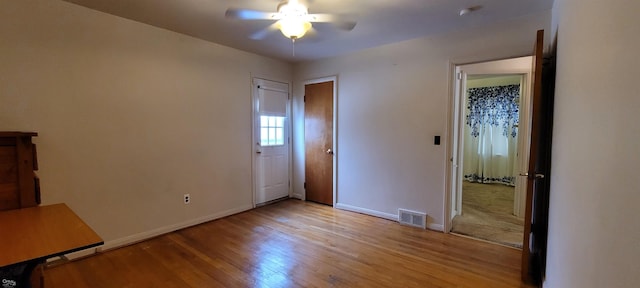 unfurnished bedroom with ceiling fan and light wood-type flooring