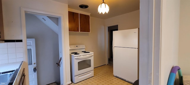 kitchen with white appliances and decorative light fixtures