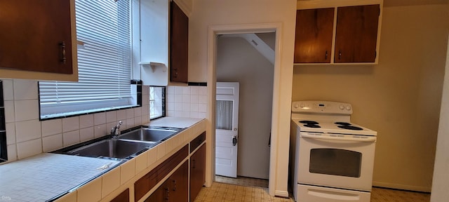 kitchen with tasteful backsplash, white electric stove, and sink