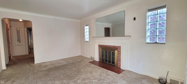 unfurnished living room with a fireplace and carpet