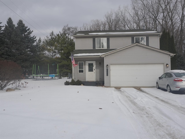 view of property with a garage and a trampoline