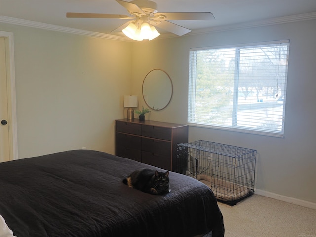 bedroom featuring baseboards, carpet floors, ornamental molding, and a ceiling fan