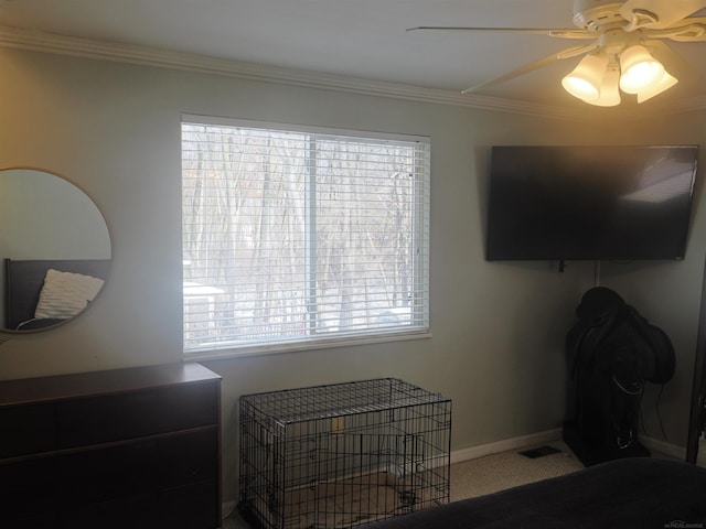 bedroom featuring visible vents, crown molding, baseboards, ceiling fan, and carpet floors