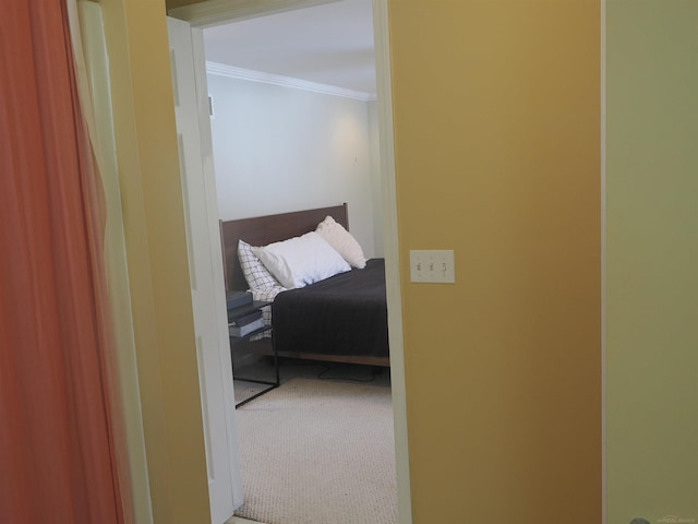 hall featuring ornamental molding and carpet flooring