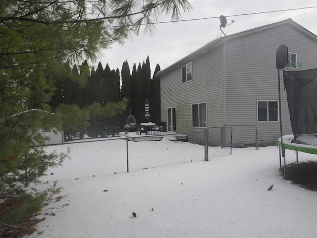 exterior space with a trampoline and fence