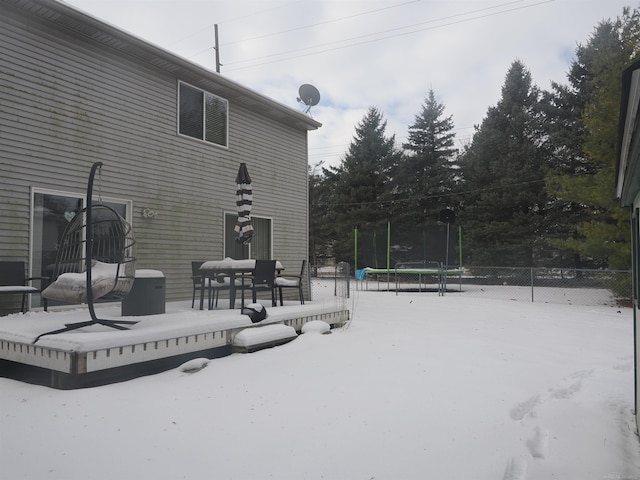 exterior space featuring a trampoline and fence