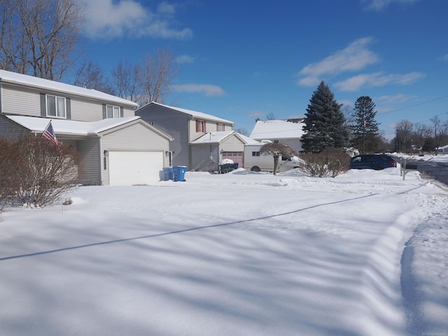 view of snowy exterior with a garage