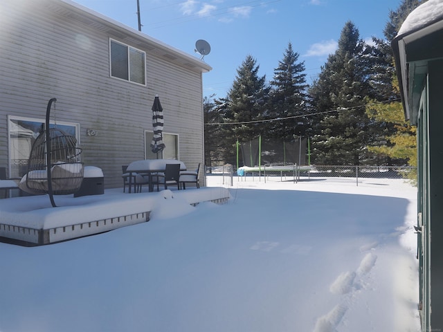 exterior space with a trampoline and fence