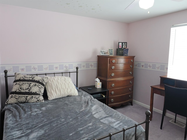 carpeted bedroom with baseboards and a ceiling fan