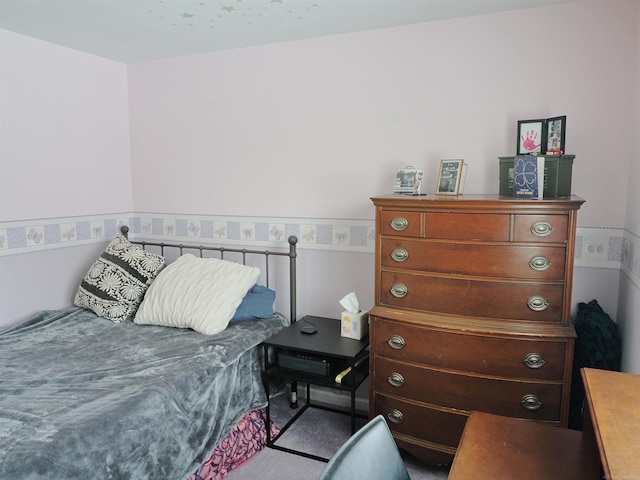 bedroom featuring wainscoting