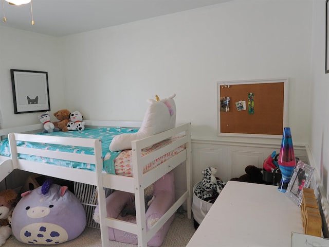 bedroom featuring a decorative wall