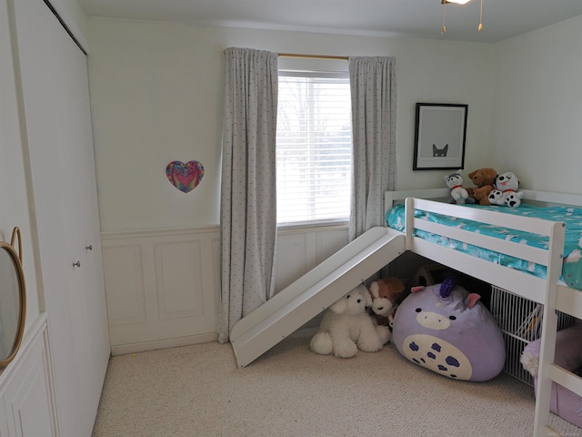 bedroom featuring wainscoting