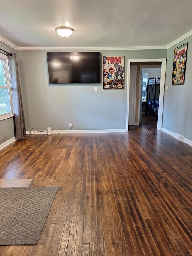 unfurnished living room featuring dark hardwood / wood-style flooring and crown molding