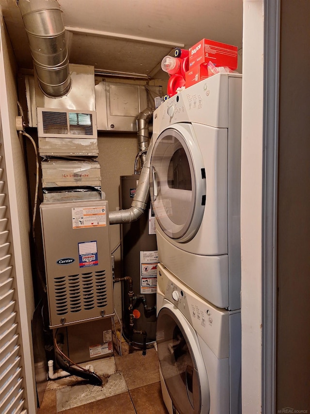 clothes washing area with stacked washing maching and dryer, heating unit, and gas water heater