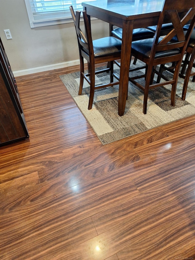 unfurnished dining area with dark wood-type flooring