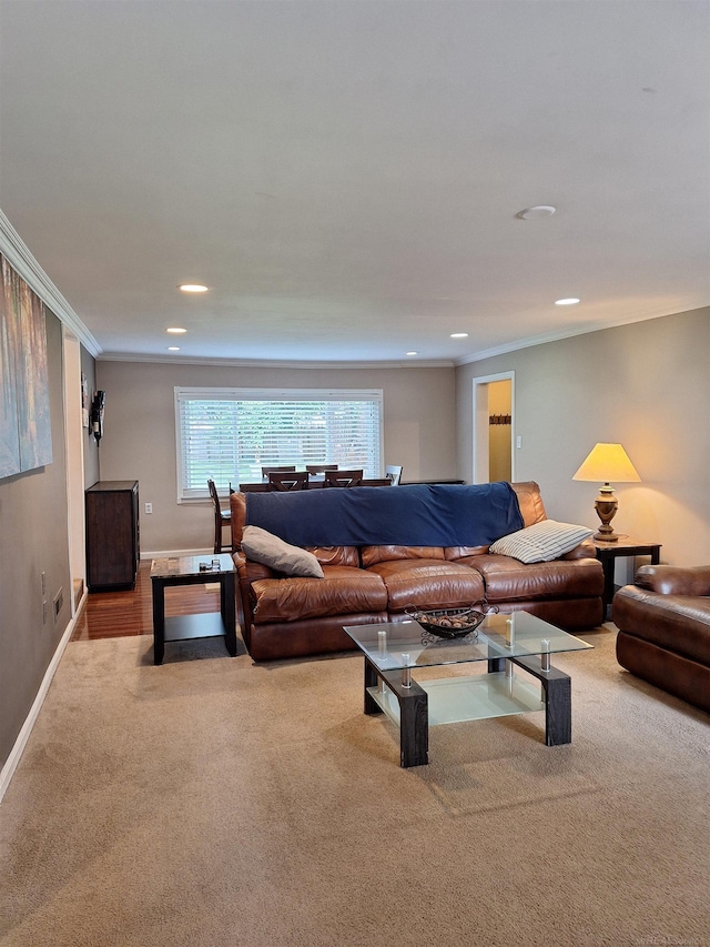 carpeted living room featuring ornamental molding