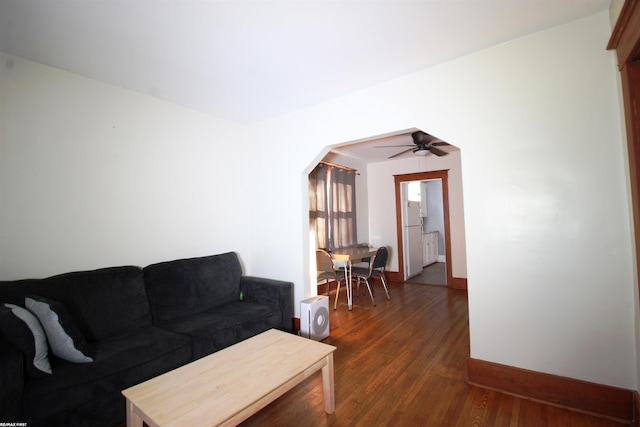 living room with ceiling fan and dark hardwood / wood-style floors