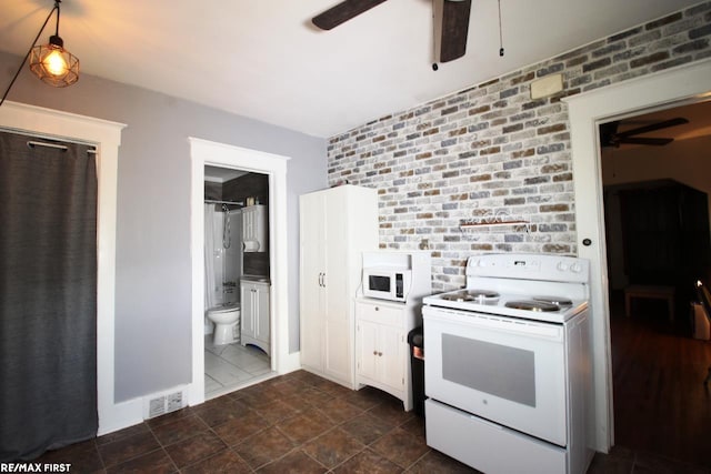 kitchen featuring white cabinetry, ceiling fan, brick wall, and white appliances