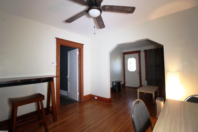 interior space featuring dark wood-type flooring and ceiling fan