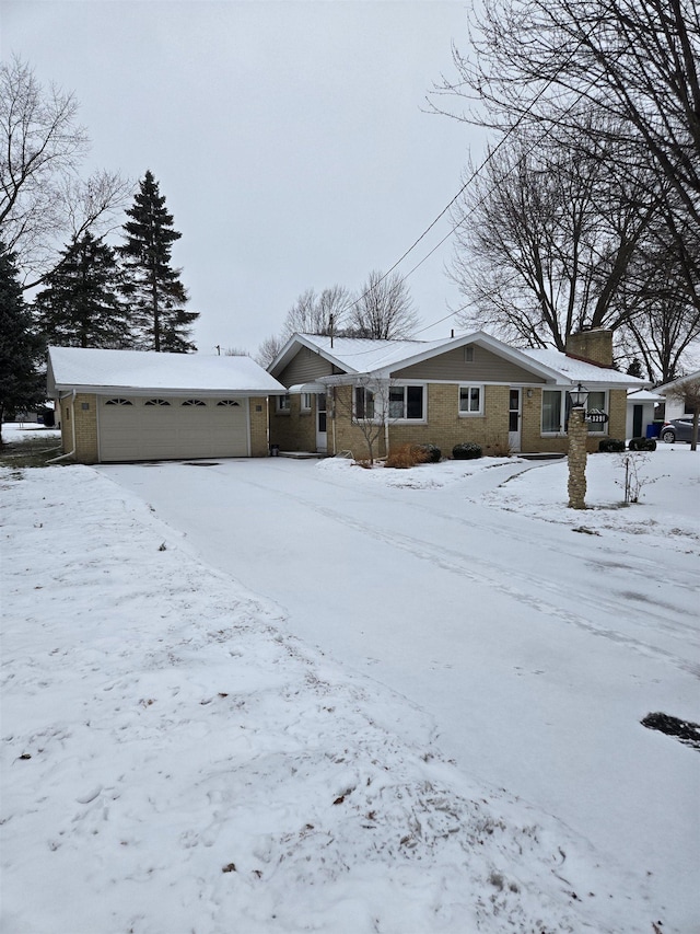 snow covered house with a garage