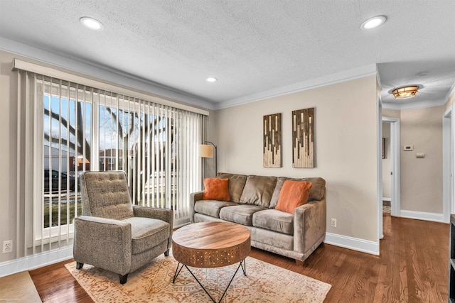 living room with crown molding, dark hardwood / wood-style flooring, and a textured ceiling