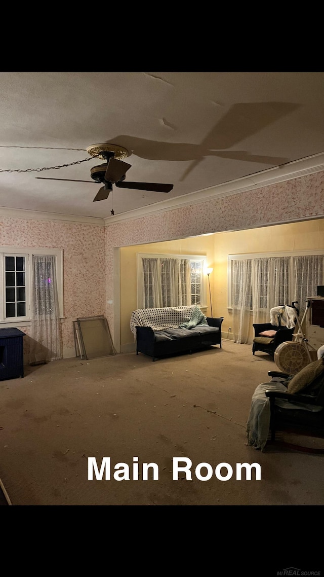 bedroom with ceiling fan, ornamental molding, and carpet floors